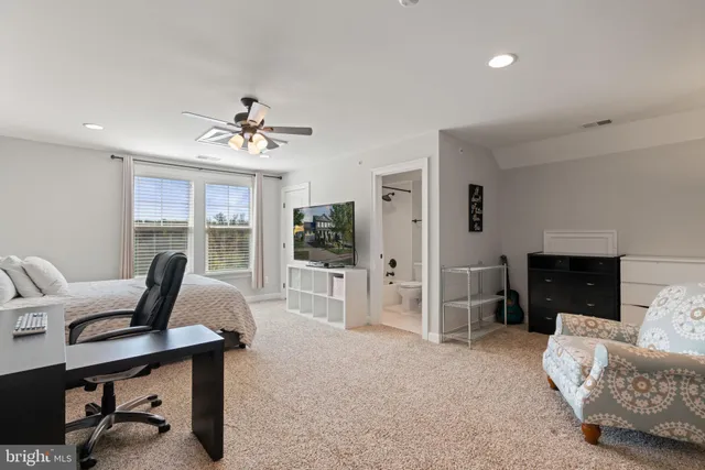 a front view of a house with a lots of flowers