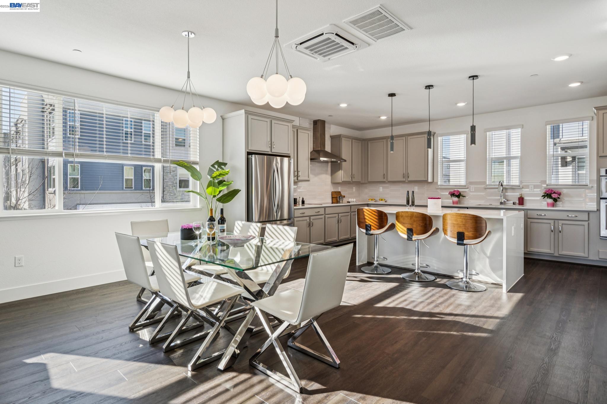 646 Eucalyptus Way Alameda, CA 94501 - Photo 15 of 40 a kitchen with stainless steel appliances kitchen island granite countertop a stove a refrigerator a sink a dining table and chairs with wooden floor