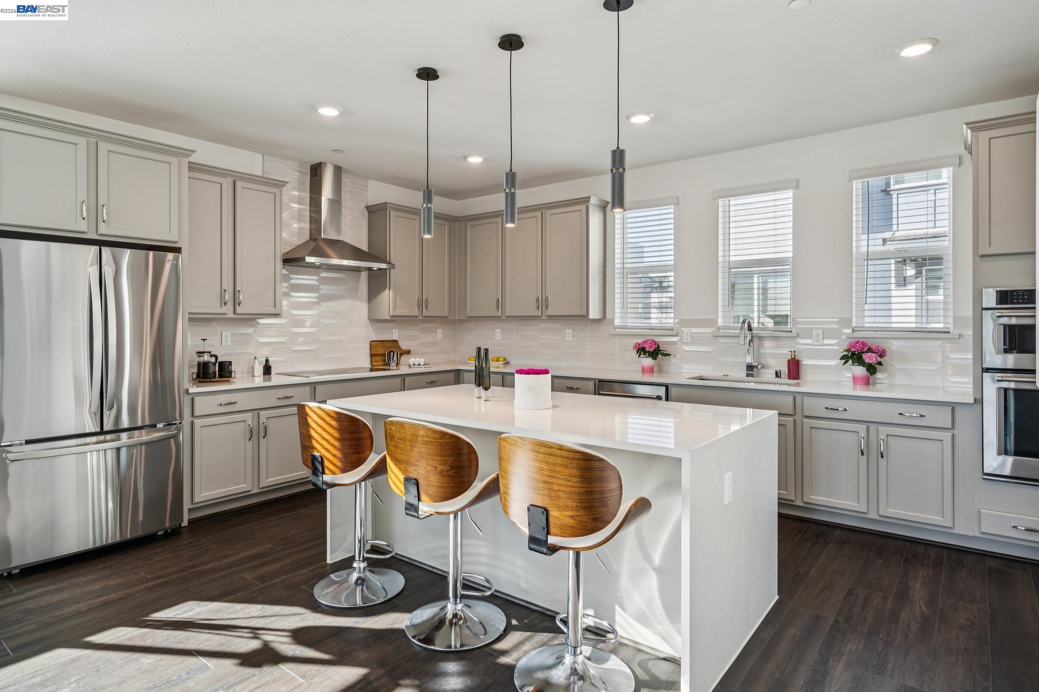 646 Eucalyptus Way Alameda, CA 94501 - Photo 17 of 40 a kitchen with granite countertop a sink a stove a refrigerator and white cabinets