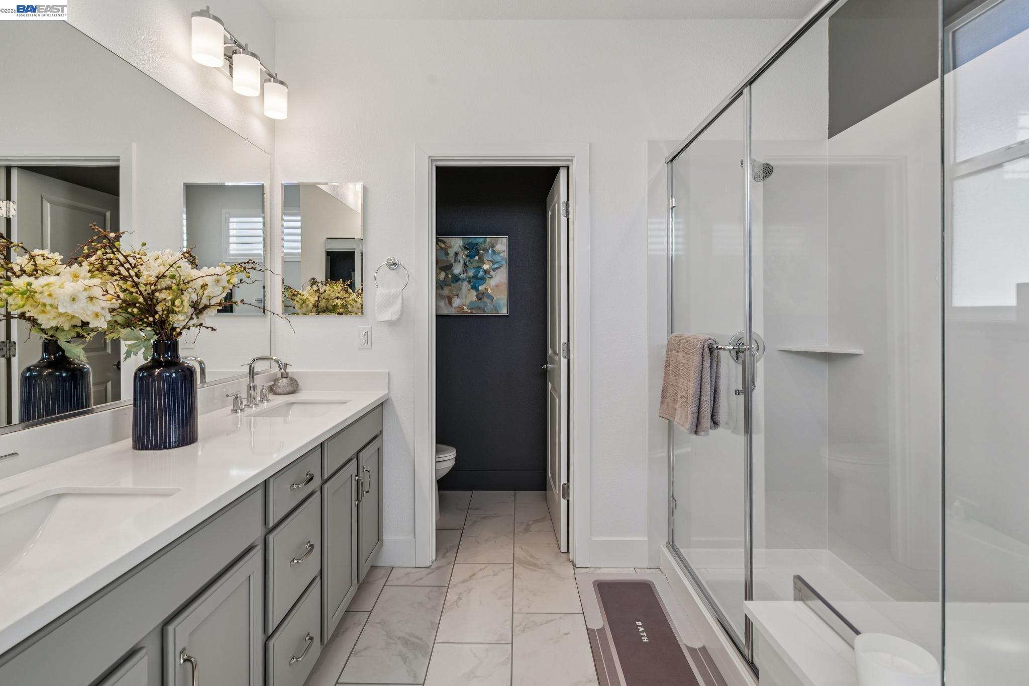 646 Eucalyptus Way Alameda, CA 94501 - Photo 26 of 40 a bathroom with a shower sink and mirror
