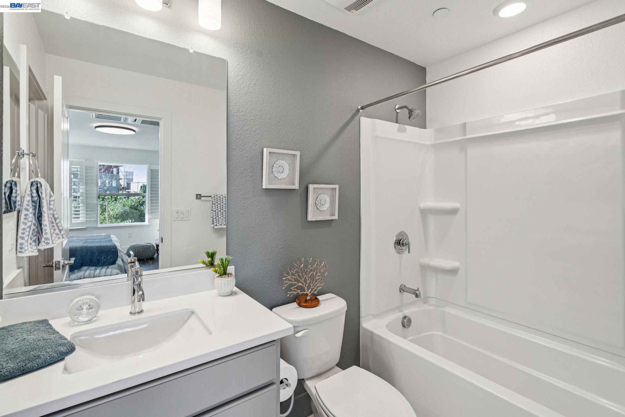 646 Eucalyptus Way Alameda, CA 94501 - Photo 9 of 40 a bathroom with a sink mirror toilet and bathtub