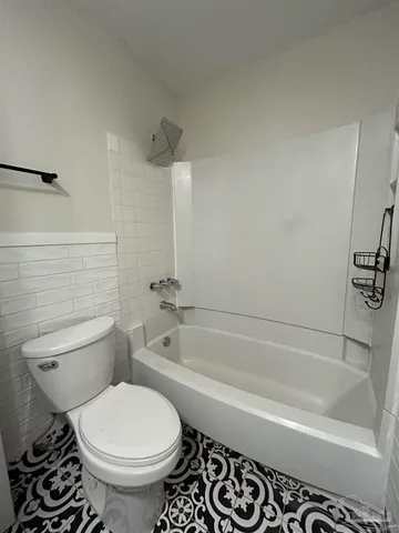 a bathroom with a toilet and a bathtub