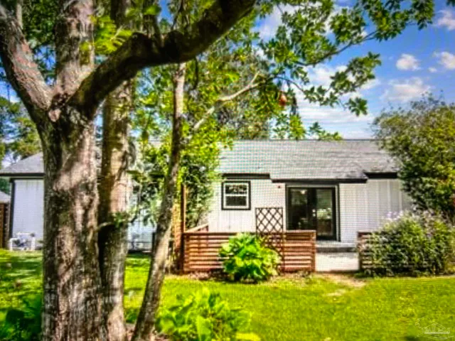 a view of house with a backyard