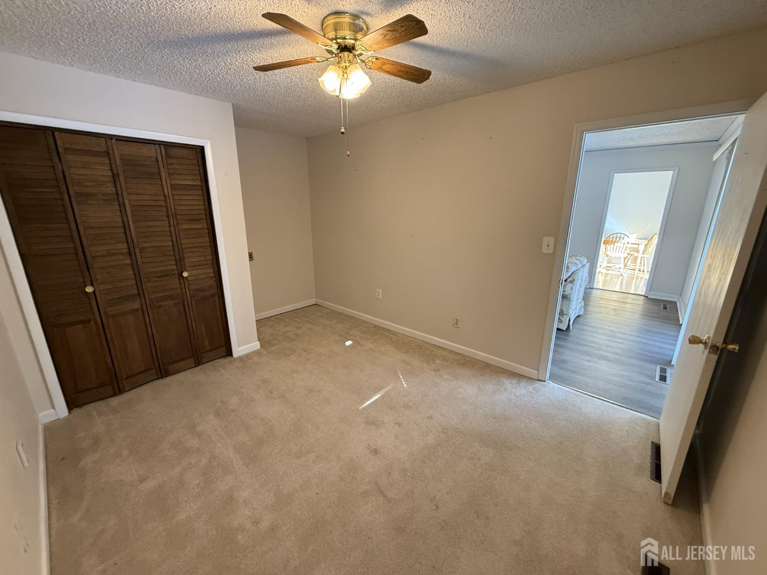 10 Tyndall Road Kendall Park, NJ 08824 - Photo 13 of 25 an empty room with windows and fan