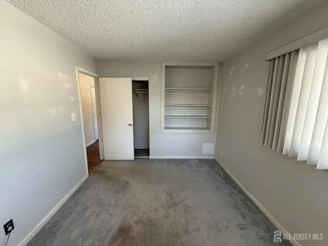 a view of a room with walk in closet and window