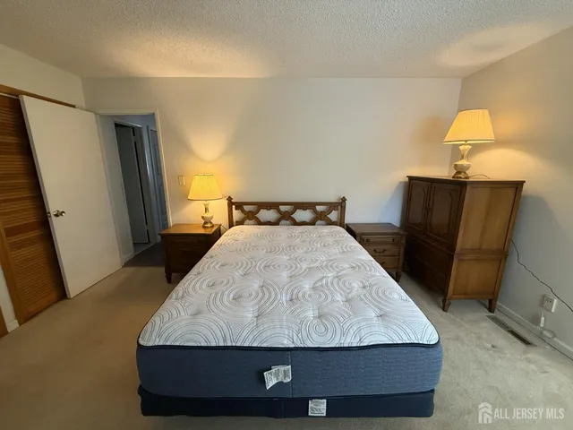 a bathroom with a sink a toilet a mirror and shower