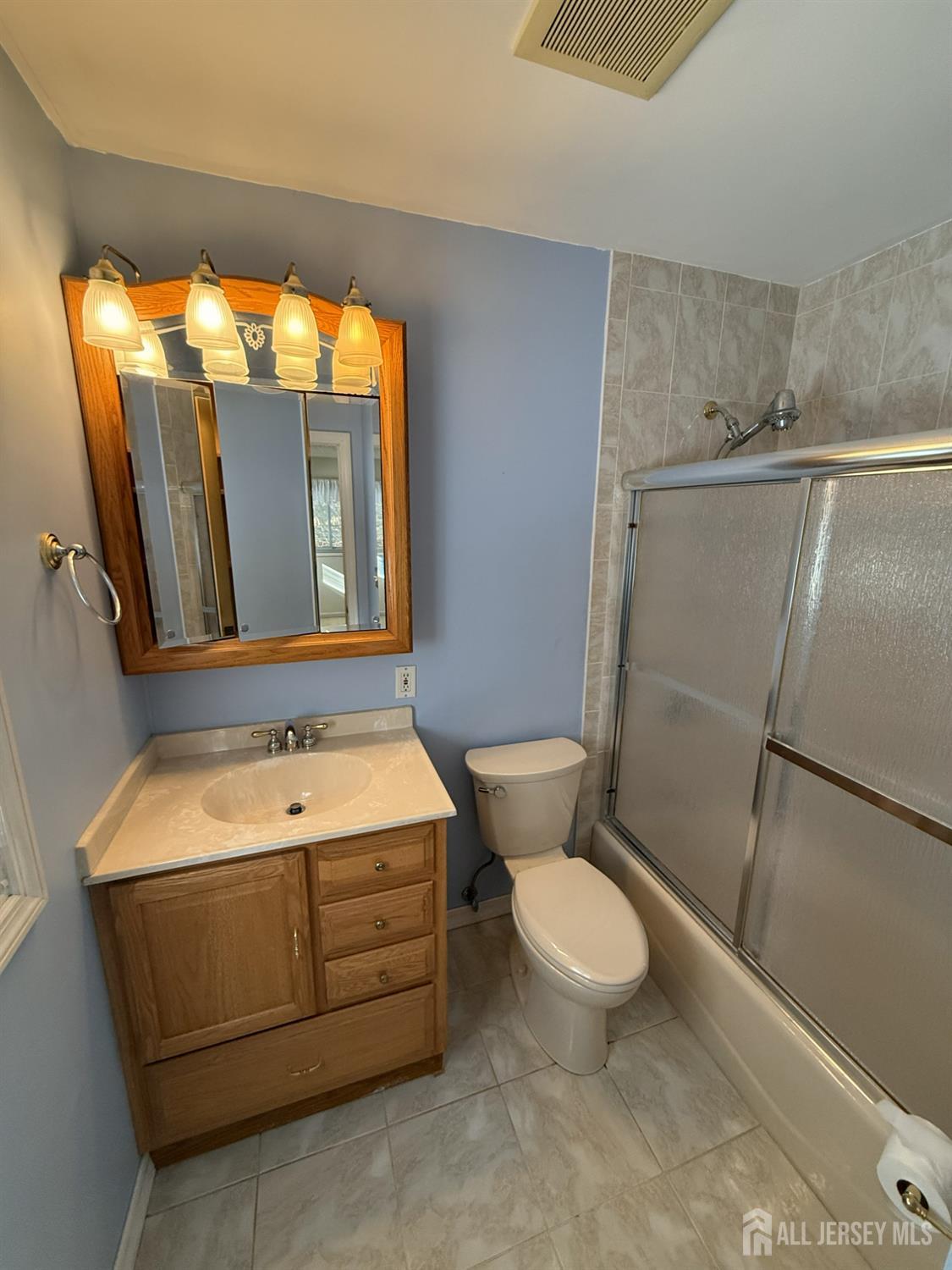10 Tyndall Road Kendall Park, NJ 08824 - Photo 21 of 25 a bathroom with a sink a toilet a mirror and shower