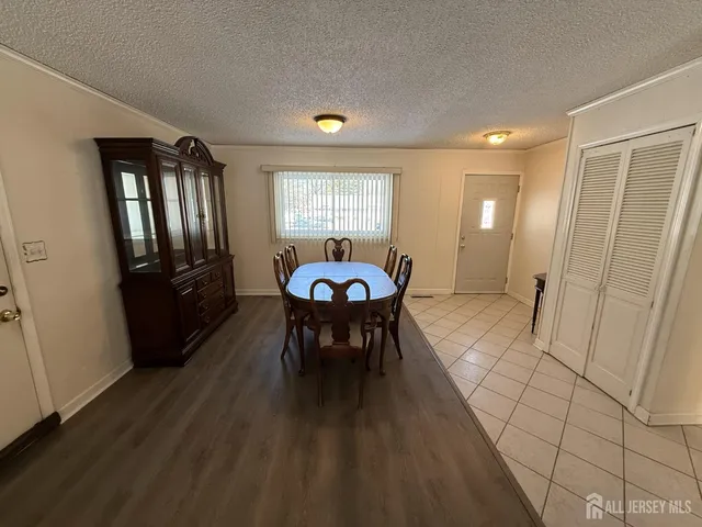 a view of a a dining room with furniture window and wooden floor