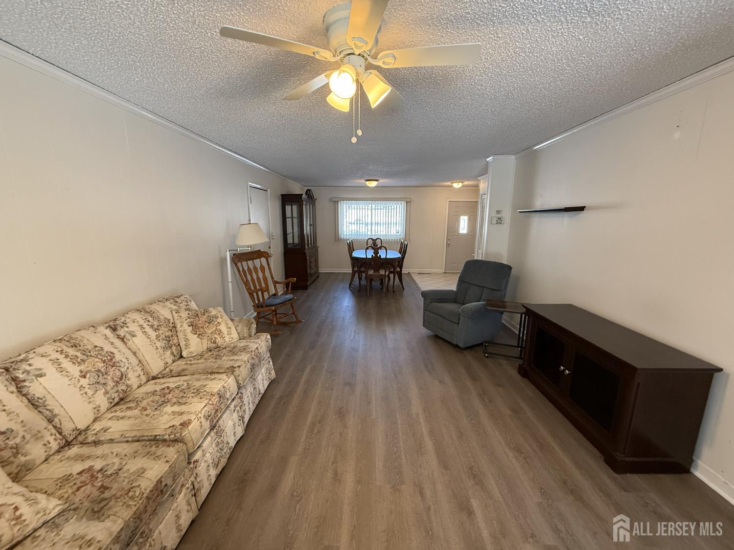 10 Tyndall Road Kendall Park, NJ 08824 - Photo 5 of 25 a living room with furniture and a chandelier