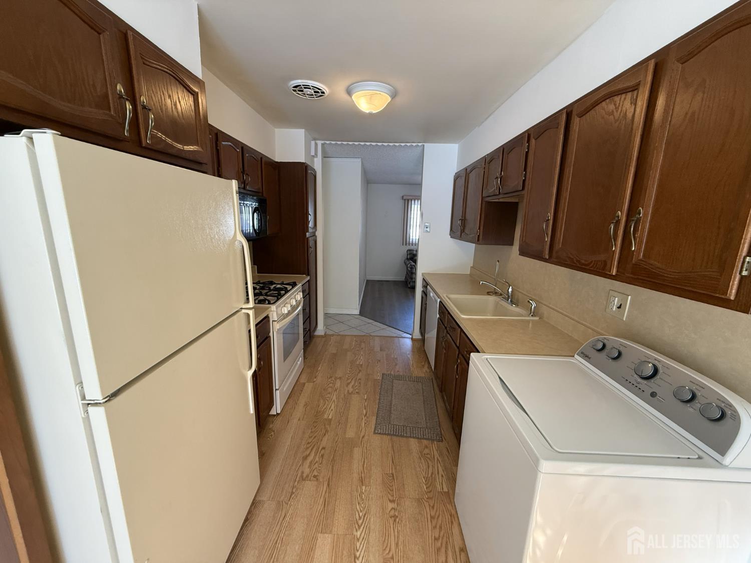 10 Tyndall Road Kendall Park, NJ 08824 - Photo 7 of 25 a utility room with wooden floor washer and dryer