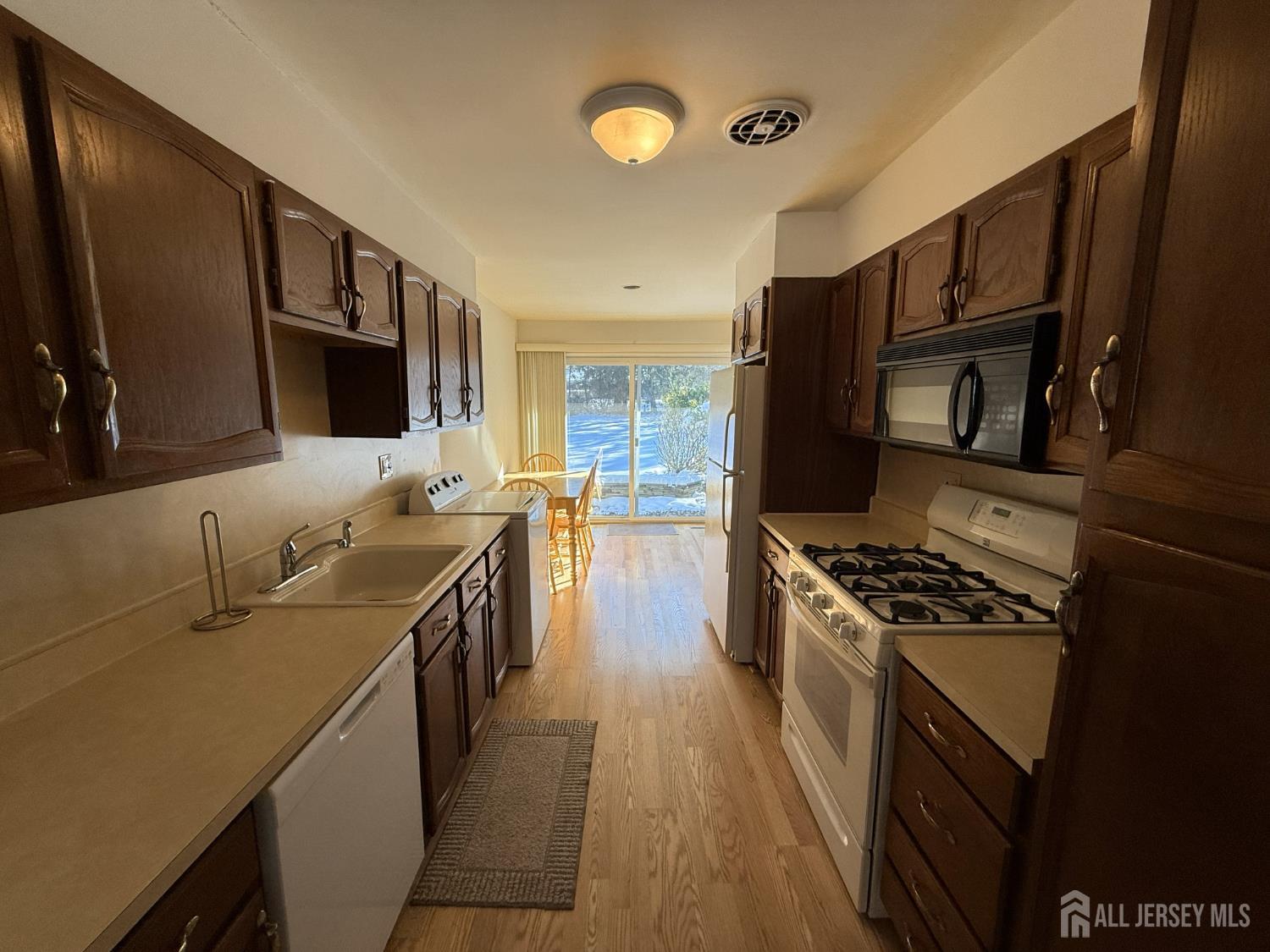 10 Tyndall Road Kendall Park, NJ 08824 - Photo 8 of 25 a kitchen with stainless steel appliances granite countertop a sink stove and refrigerator