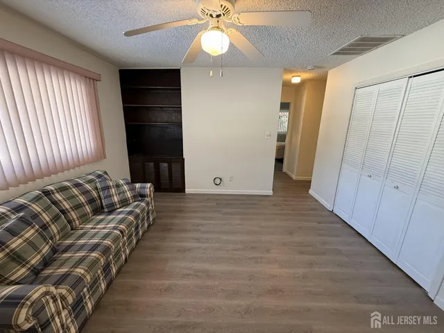 a view of livingroom with furniture and chandelier fan