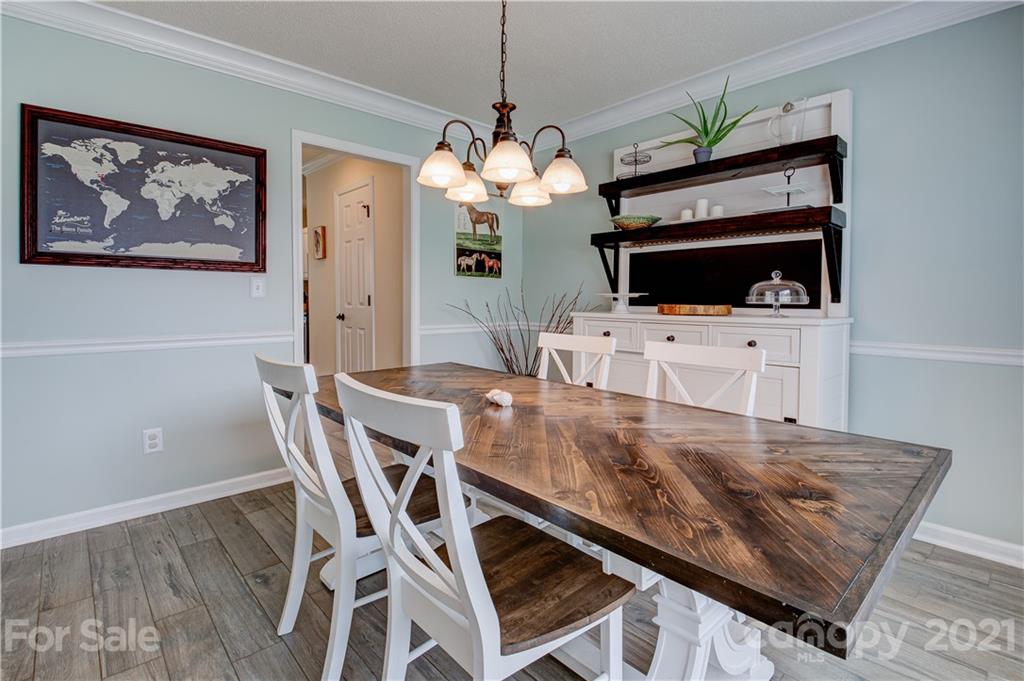 127 Yadkin Road Fletcher, NC 28732 - Photo 2 of 25 a view of a dining room with furniture and a fireplace