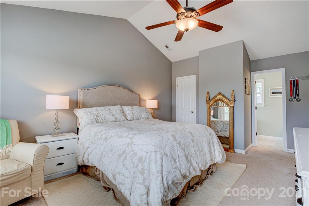 127 Yadkin Road Fletcher, NC 28732 - Photo 12 of 25 a bedroom with bed and a chandelier
