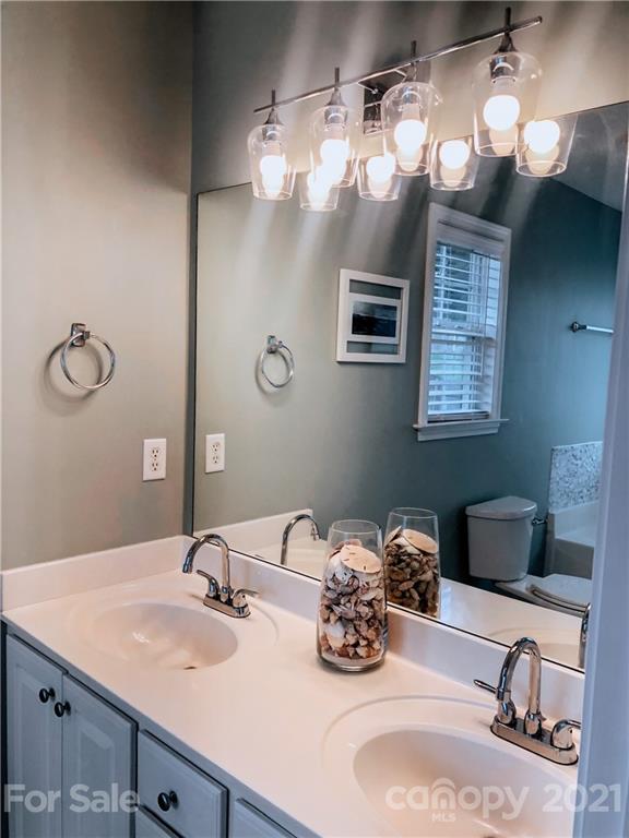 127 Yadkin Road Fletcher, NC 28732 - Photo 14 of 25 a bathroom with a sink double vanity and a mirror
