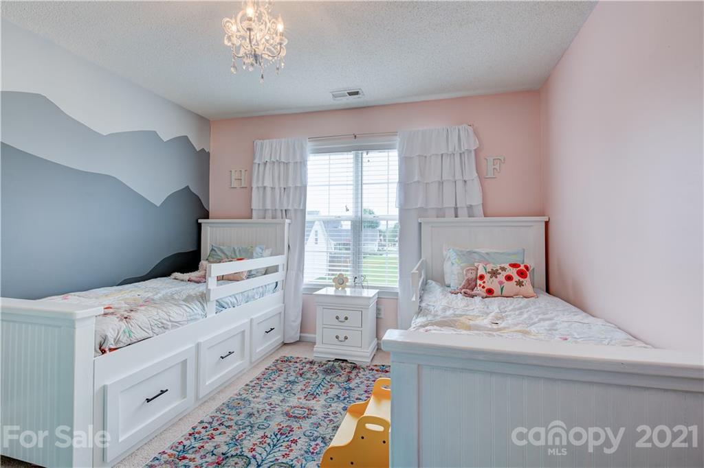 127 Yadkin Road Fletcher, NC 28732 - Photo 16 of 25 a bedroom with a bed and a window
