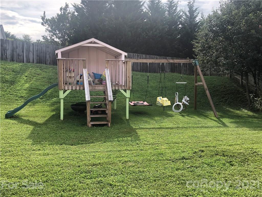 127 Yadkin Road Fletcher, NC 28732 - Photo 23 of 25 a view of a wooden deck and a yard with green space