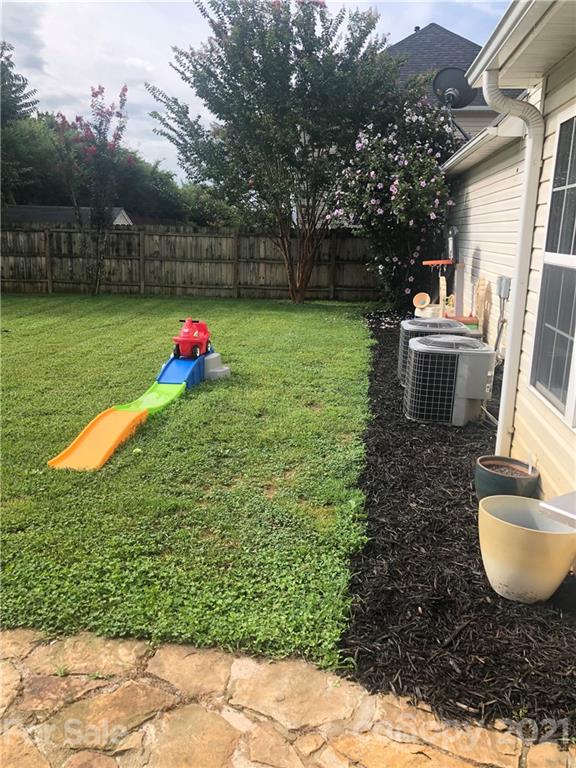 127 Yadkin Road Fletcher, NC 28732 - Photo 24 of 25 a view of a backyard with a garden and entertaining space