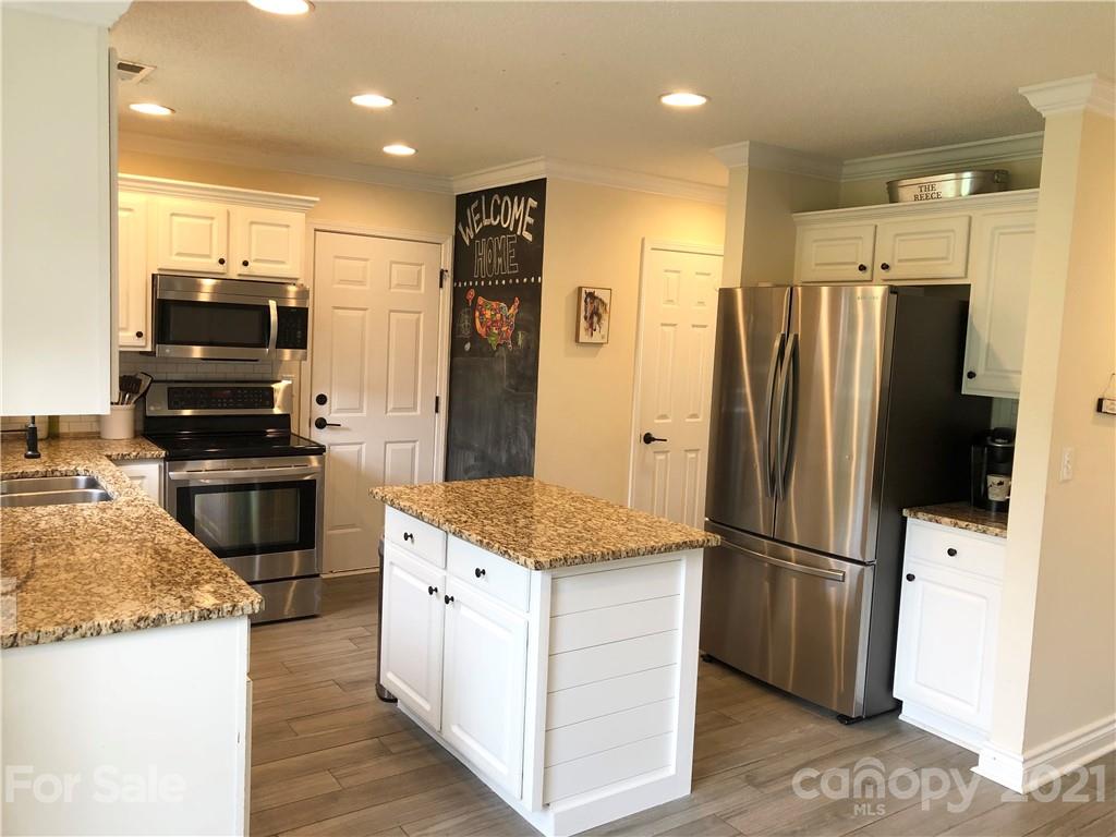 127 Yadkin Road Fletcher, NC 28732 - Photo 4 of 25 a kitchen with stainless steel appliances granite countertop a refrigerator stove and microwave