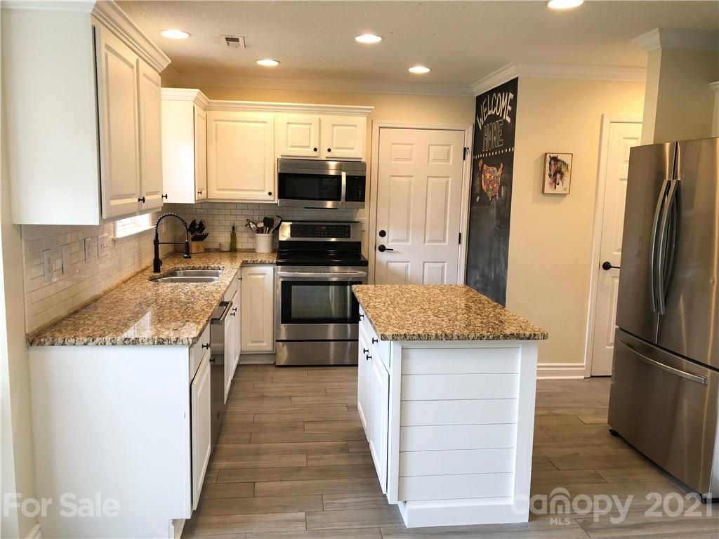 127 Yadkin Road Fletcher, NC 28732 - Photo 5 of 25 a kitchen with a refrigerator sink and microwave