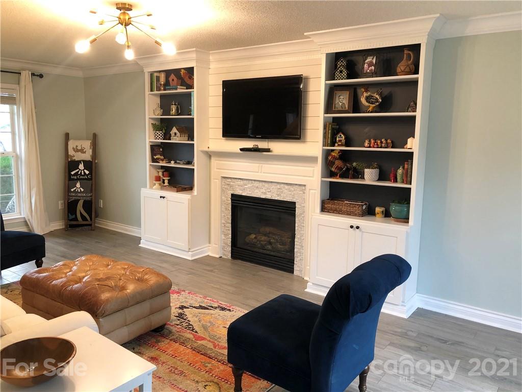 127 Yadkin Road Fletcher, NC 28732 - Photo 8 of 25 a living room with furniture and a flat screen tv