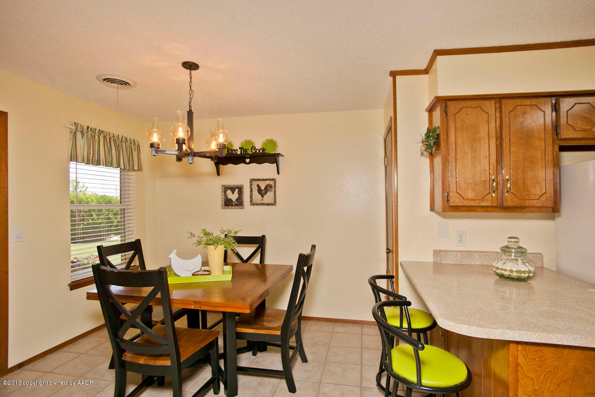 5713 South Milam Street Amarillo, TX 79110 - Photo 8 of 22 a view of a dining room with furniture and a window
