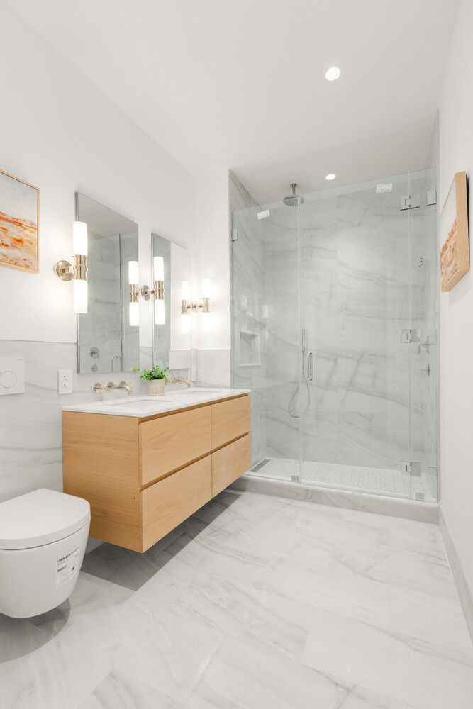 46 East 65th Street, Unit 4 Manhattan, NY 10065 - Photo 6 of 18 a bathroom with a sink a toilet and shower