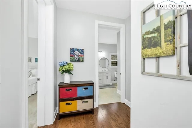 a view of a dining room with furniture a chandelier and wooden floor