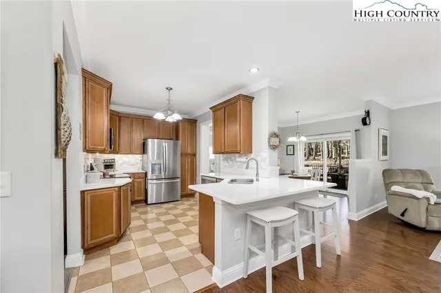 a kitchen with stainless steel appliances a sink stove and refrigerator