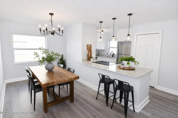 a view of a dining room with furniture and wooden floor