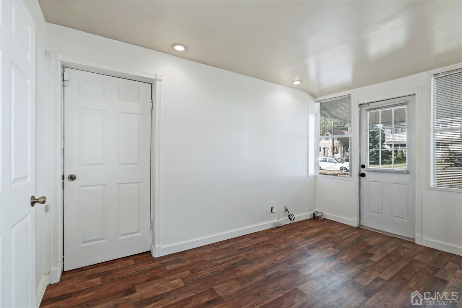 575 New Dover Road Iselin, NJ 08830 - Photo 22 of 28 an empty room with wooden floor and windows