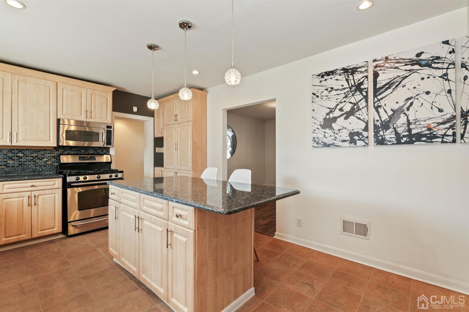 575 New Dover Road Iselin, NJ 08830 - Photo 8 of 28 a kitchen with stainless steel appliances kitchen island granite countertop a refrigerator and a stove top oven