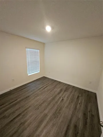 a view of an empty room and wooden floor