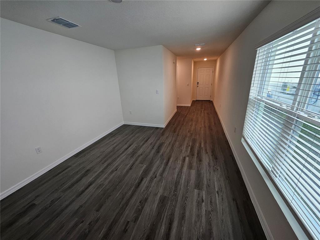 2636 Hardin Way Zephyrhills, FL 33541 - Photo 22 of 42 a view of wooden floor in an empty room