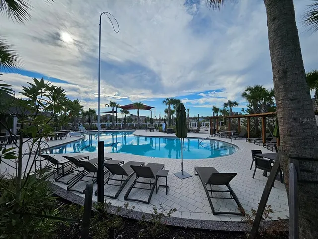 a view of a patio with table and chairs potted plants with wooden fence