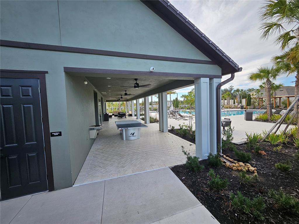 2636 Hardin Way Zephyrhills, FL 33541 - Photo 39 of 42 a view of a patio with table and chairs potted plants with wooden fence