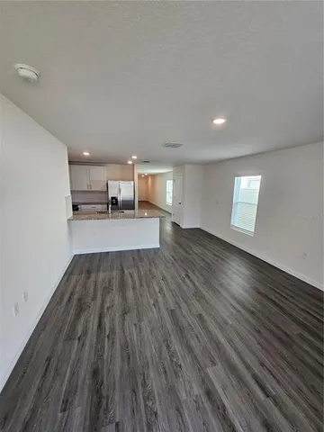 a view of a room with wooden floor and window