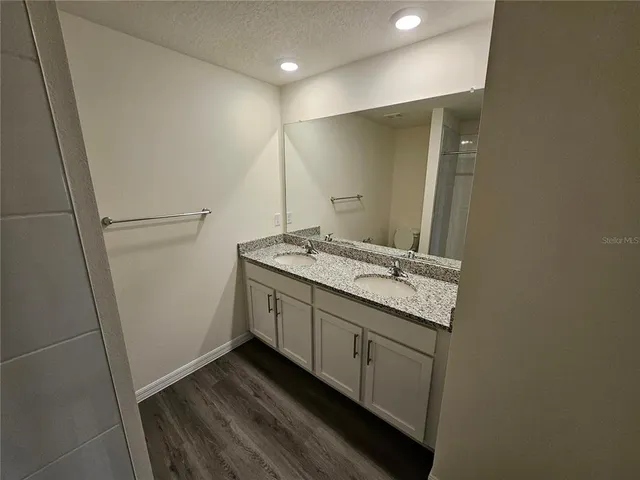 a bathroom with a sink a mirror and a shower