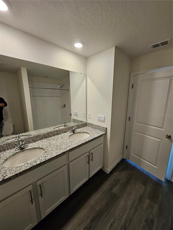 2636 Hardin Way Zephyrhills, FL 33541 - Photo 10 of 42 a bathroom with a granite countertop sink and a mirror