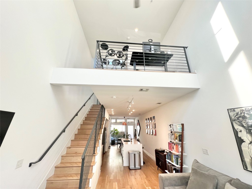 2002 East 7th Street, Unit 223 Austin, TX 78702 - Photo 1 of 14 a view of a hallway with wooden floor and dining room