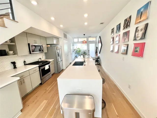 a large white kitchen with a large window