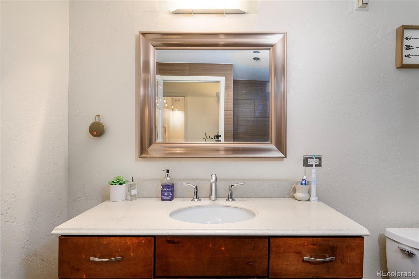 444 17th Street, Unit 904 Denver, CO 80202 - Photo 15 of 18 a bathroom with a sink vanity and mirror