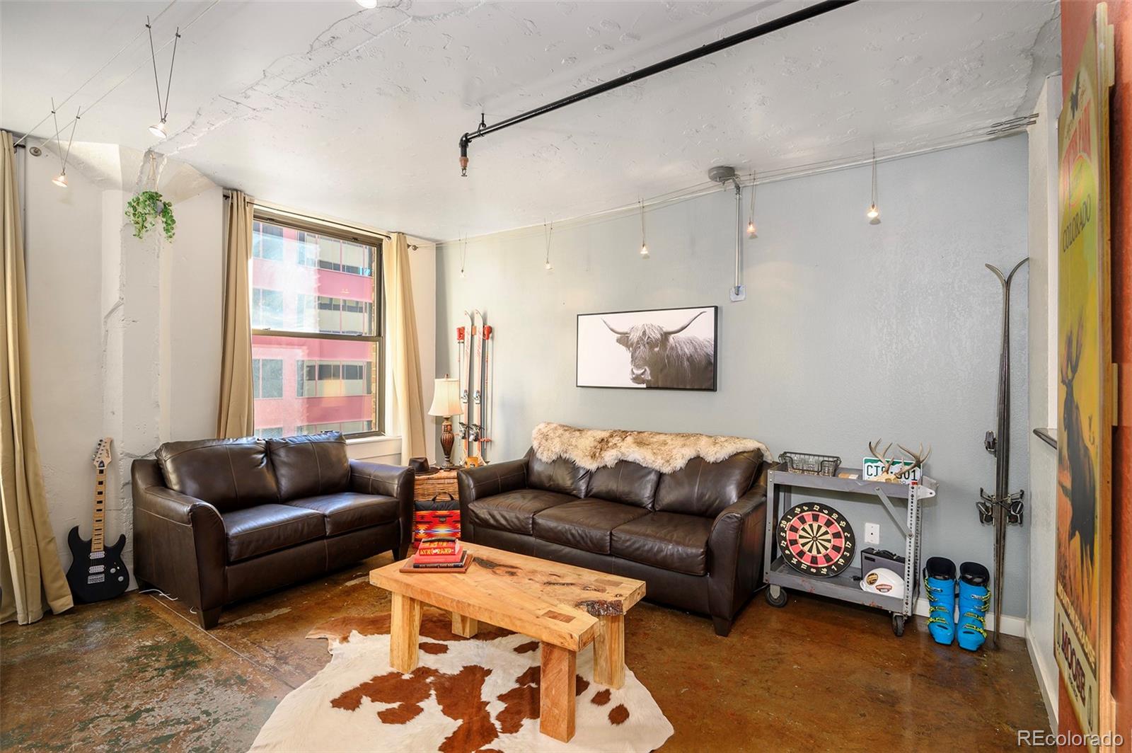 444 17th Street, Unit 904 Denver, CO 80202 - Photo 5 of 18 a living room with furniture and a couch