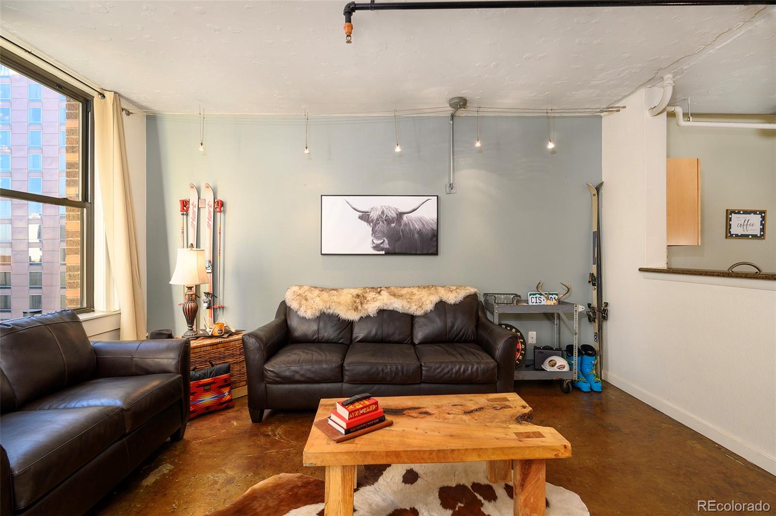 444 17th Street, Unit 904 Denver, CO 80202 - Photo 7 of 18 a living room with furniture and a large window