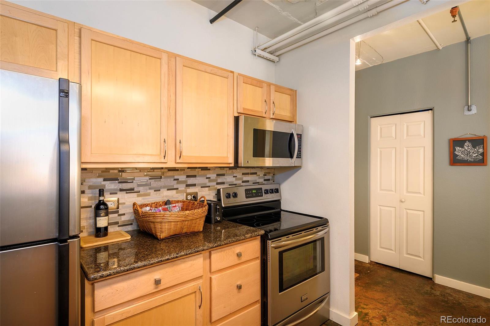 444 17th Street, Unit 904 Denver, CO 80202 - Photo 10 of 18 a kitchen with a stove and a microwave