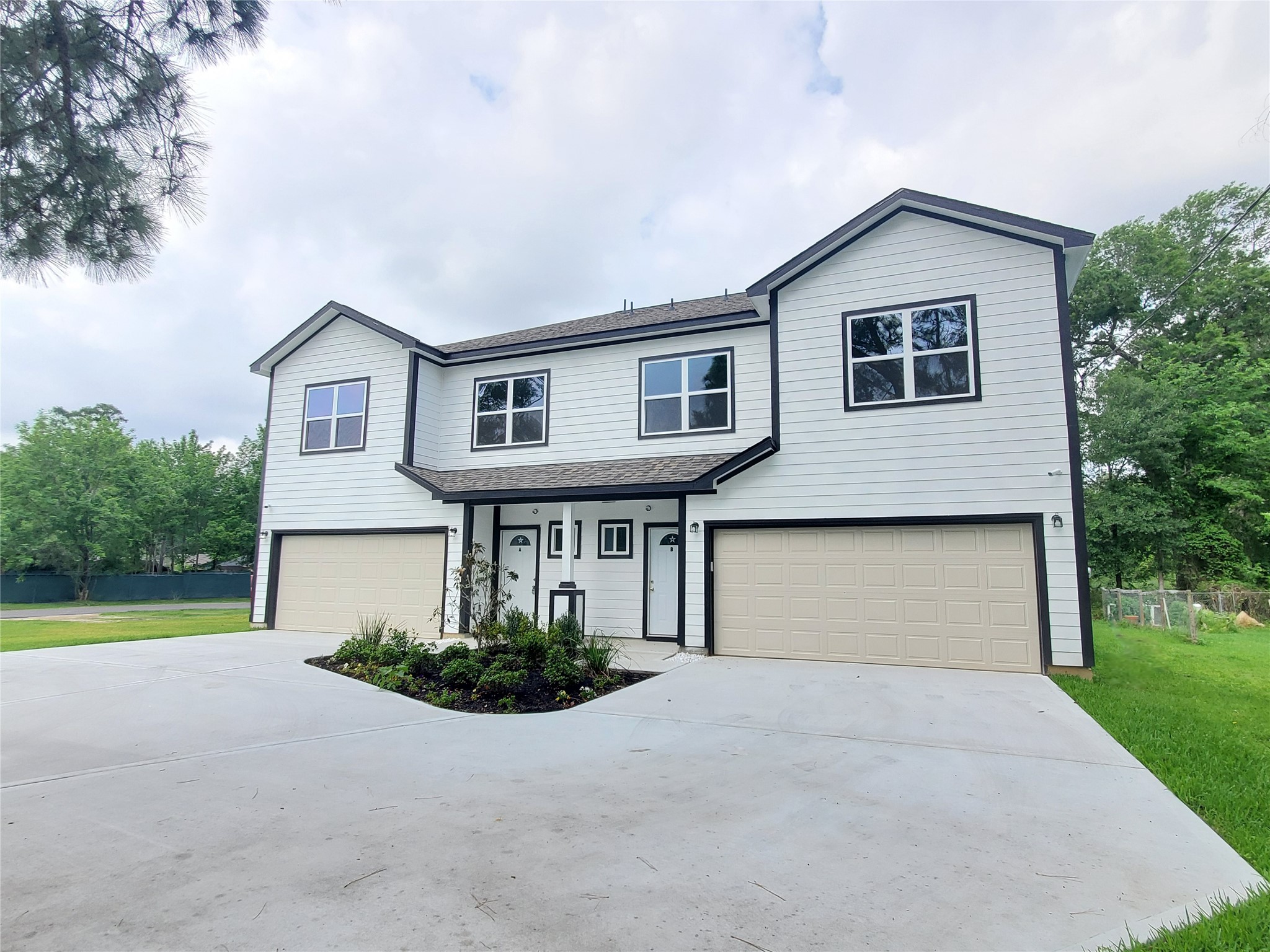 1306 North 9th Street Conroe, TX 77301 - Photo 2 of 47 a front view of a house with garden