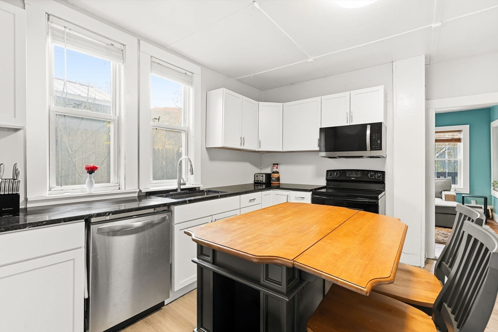 23 Fletcher Place Athol, MA 01331 - Photo 6 of 29 a kitchen with stainless steel appliances a stove a sink and a microwave