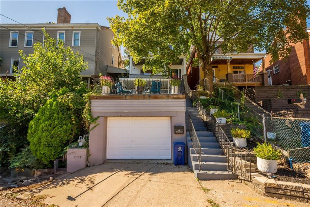 324 Merrimac Street Pittsburgh, PA 15211 - Photo 1 of 37 a front view of a house with a garage