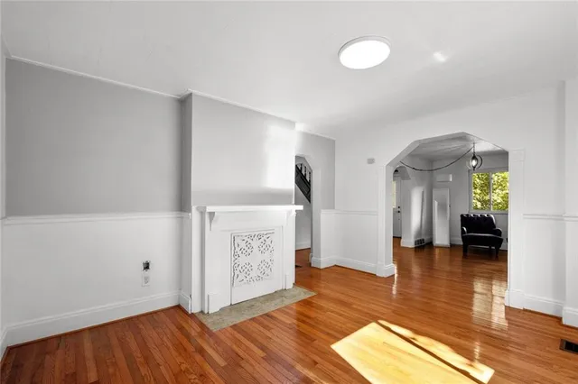 a view of a room with wooden floor