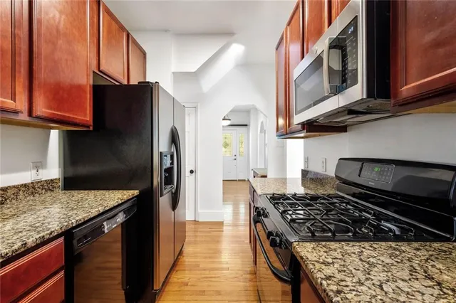 a kitchen with stainless steel appliances granite countertop a stove and a refrigerator